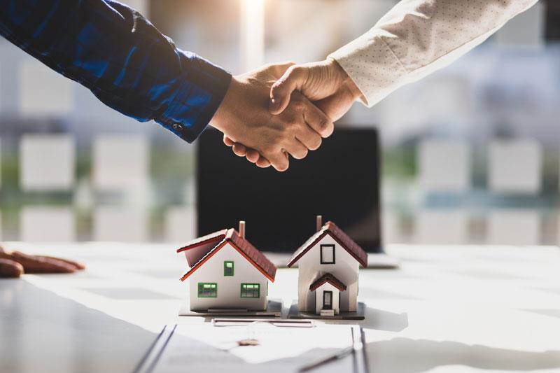 Two people shaking hands for a deal